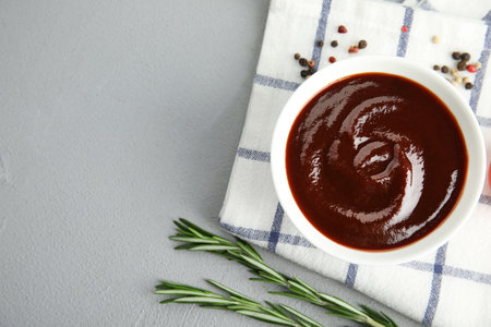 Flat lay composition with barbecue sauce on gray background. Space for textの写真素材