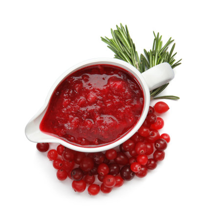 Pitcher of cranberry sauce with rosemary on white background, top viewの写真素材