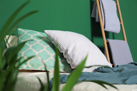 Soft pillows and plaid on comfortable bed indoors. Idea for interior designの写真素材