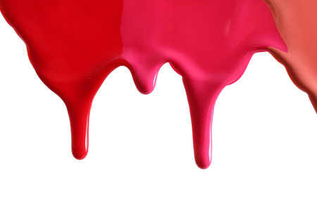 Different color nail polishes flowing on white backgroundの写真素材