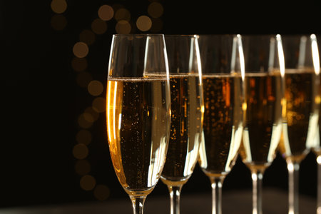 Glasses of champagne on blurred background, closeup. Space for textの写真素材