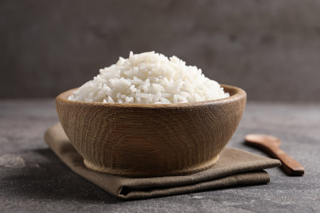 Bowl of tasty cooked rice served on tableの写真素材