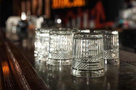 Empty clean glasses on counter in modern barの写真素材