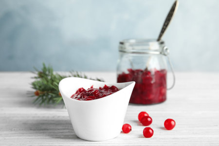 Bowl of tasty cranberry sauce on tableの写真素材