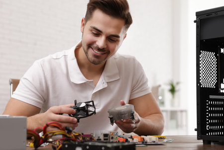 Male technician repairing computer at table indoorsの写真素材