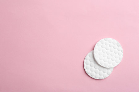 Cotton pads on color background, top view. Space for textの写真素材