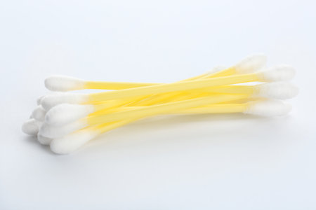 Yellow plastic cotton swabs on white backgroundの写真素材