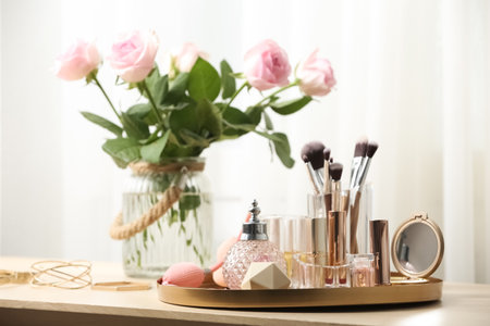 Different makeup products and accessories on dressing table in room interiorの写真素材