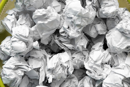 Closeup of metal bin with crumpled paper, top viewの写真素材