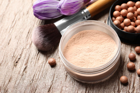 Makeup products and spring flowers on color background, closeup. Space for textの写真素材