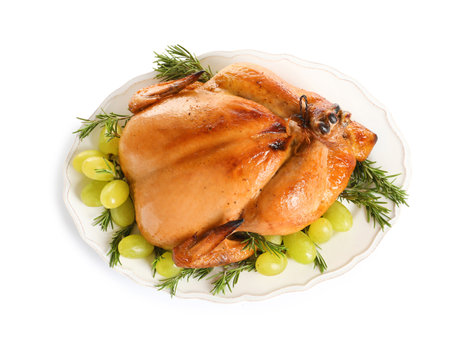 Platter of cooked turkey with garnish on white background, top viewの写真素材