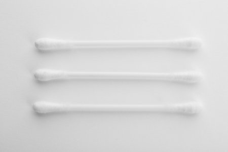 Plastic cotton swabs on white background, top view