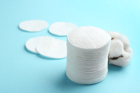 Cotton pads on color background. Space for textの写真素材