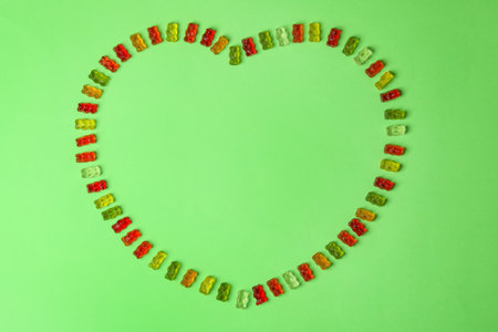 Flat lay composition with delicious jelly bears on color background. Space for textの写真素材