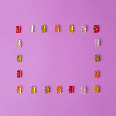 Flat lay composition with delicious jelly bears on color background. Space for textの写真素材