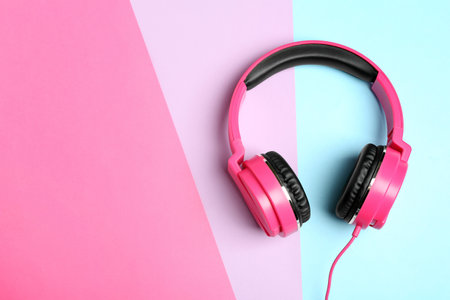 Stylish headphones on color background, top view. Space for textの写真素材