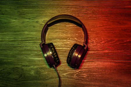 Stylish headphones on wooden background, top viewの写真素材