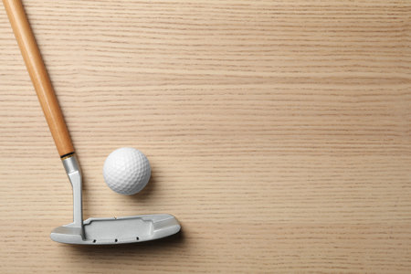 Golf club and ball on wooden background, flat lay with space for textの写真素材
