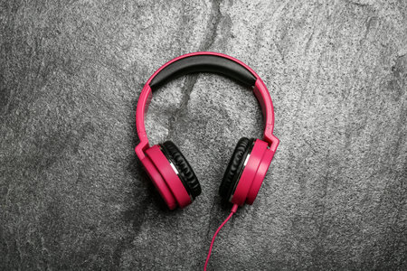 Stylish headphones on gray background, top view