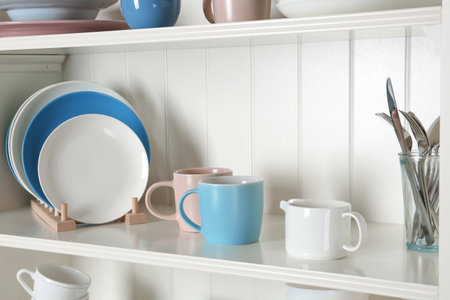 White shelving unit with set of dishwareの写真素材