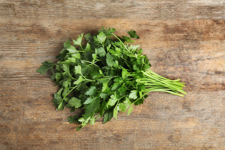 Bunch of fresh green parsley on wooden background, view from aboveの写真素材