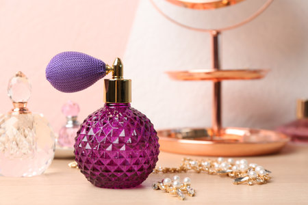 Perfume bottles and jewelery on dressing table