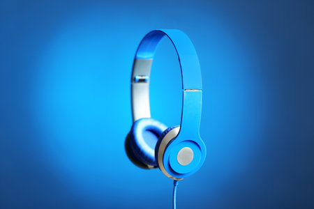Stylish headphones with pads on color backgroundの写真素材