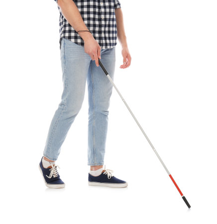 Blind person with long cane walking on white backgroundの写真素材