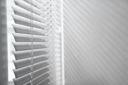 Window with closed horizontal blinds indoors. Space for textの写真素材