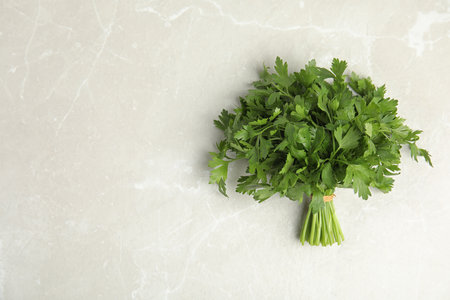 Bunch of fresh green parsley on light background, view from above. Space for textの写真素材