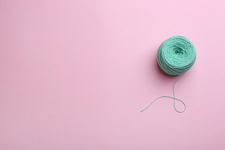 Clew of knitting threads on color background, top view with space for text. Sewing stuffの写真素材