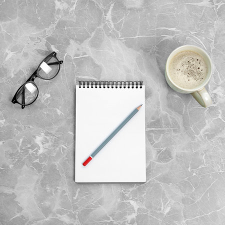 Flat lay composition with office stationery and cup of coffee on marble tableの写真素材