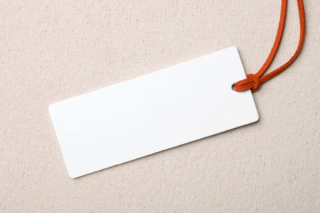 Cardboard tag with space for text on color fabric, top view