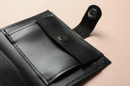 Open leather wallet on color background, closeup