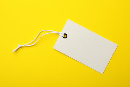 Cardboard tag with space for text on color background, top viewの写真素材