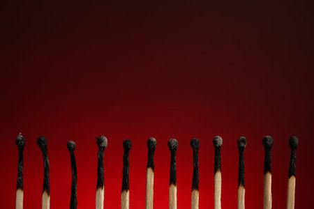 Line of burnt matches on color background. Space for textの写真素材