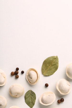 Composition with raw dumplings, bay leaves and pepper, top viewの写真素材