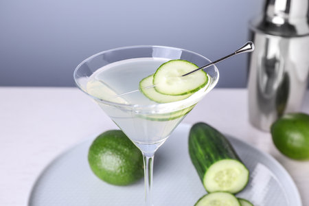 Composition with glass of cucumber martini on table against color background, closeupの写真素材