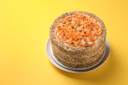 Dish with delicious carrot cake on color background. Space for textの写真素材