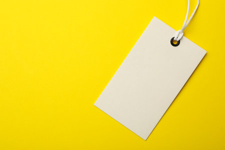 Cardboard tag with space for text on color background, top viewの写真素材