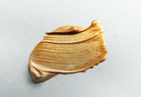 golden paint brush stroke on white background