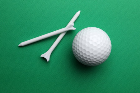 Golf ball and tees on color background, flat lay. sport equipmentの写真素材