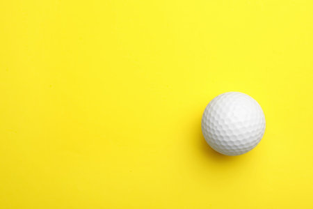 Golf ball on color background, top view. Space for textの写真素材