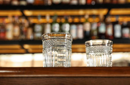 Empty clean glasses on counter in modern bar, low angle viewの写真素材