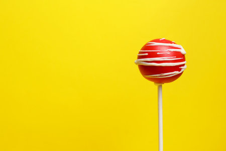 Bright delicious cake pop on color background. Space for textの写真素材