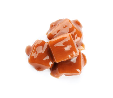 Delicious candies with caramel sauce on white background, top viewの写真素材