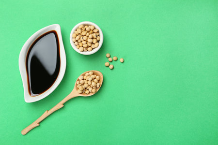 Flat lay composition with soy sauce and beans on color background. Space for textの写真素材