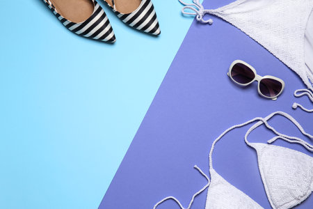 Flat lay composition with stylish bikini on color background. Space for textの写真素材