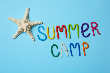 Text SUMMER CAMP made of modeling clay and starfish on color background, flat layの写真素材