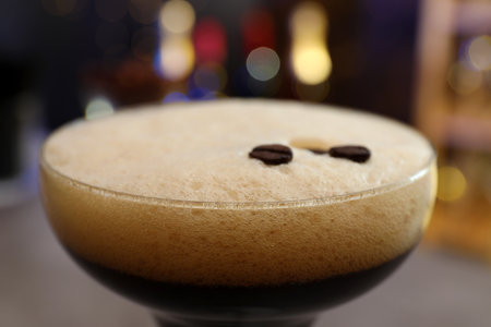 Glass of Espresso Martini with coffee beans on blurred background, closeup. alcohol cocktailの写真素材